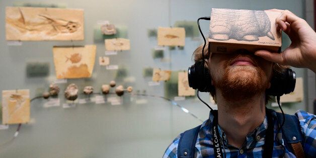 A journalist uses a smartphone equipped with a so-called 'Google Cardboard' mount to use it as a VR (virtual reality) device for trying out a new offer developed by Google's platform 'Google Arts & Culture' and the Museum of Natural History (Naturkundemuseum) in Berlin on September 13, 2016 at the museum.In cooperation with natural history museums all over the World, 'Google Arts & Culture' launched a new offer that makes possible a new approach to the exhibits, for example with virtual tours, 3
