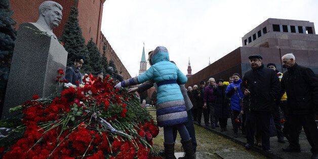 MOSCOW, RUSSIA - DECEMBER 21: Russians lay flowers at Joseph Stalin's memorial during a commemoration of the 135th birthday of the Soviet leader Stalin at Red Square in Moscow, Russia on December 21, 2014. (Photo by Sefa Karacan/Anadolu Agency/Getty Images)