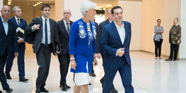 Greek Prime Minister Alexis Tsipras (R) talks with International Monetary Fund (IMF) Managing Director Christine Lagarde at the IMF headquarters in Washington, DC, October 16, 2017. / AFP PHOTO / JIM WATSON (Photo credit should read JIM WATSON/AFP/Getty Images)