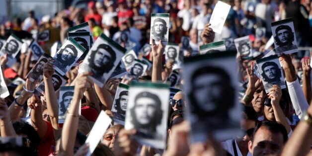 SANTA CLARA, CUBA OCT 08: Cubans wave holding photos of Che Guevara during a political act at the Plaza de la Revolucion to celebrate the 50th anniversary of the death of Ernesto Che Guevara, on October 8, 2017 in Santa Clara, Cuba. Che Guevara was killed in La Higuera, Bolivia, on October 9, 1967 and his remains were buried in Santa Clara in 1997. (Photo by Sven Creutzmann/Mambo photo/Getty Images)