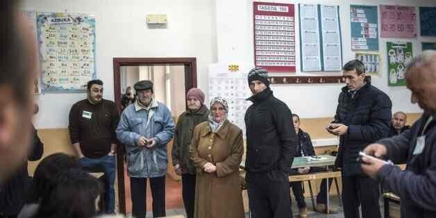 People queue to cast their ballots at a polling station in Tearce, northwestern Macedonia, on December 25, 2016, during a parliamentary election re-vote in this polling station only, annuled due to irregularities.The repeat of the vote at the polling station with some 700 voters in the western town of Tearce in the ethnic Albanian dominated region of Tetovo could challenge the narrow victory of ruling conservatives. The original December 11 vote was part of a European Union-brokered deal between Macedonia's four main political parties in a bid to solve a deep political crisis emerging after a mass wiretapping scandal erupted in February 2015 and sparked street protests. / AFP / Robert ATANASOVSKI (Photo credit should read ROBERT ATANASOVSKI/AFP/Getty Images)