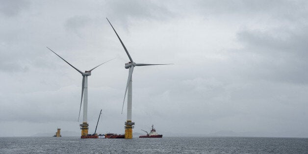 Barges position offshore floating wind turbines during assembly in the Hywind pilot park, operated by Statoil ASA, in Stord, Norway, on Friday, June 23, 2017. The world's first offshore floating wind farm will be moved to its final destination outside Peterhead, Scotland, later this summer to provide clean energy to 20,000 British households. Photographer: Carina Johansen/Bloomberg via Getty Images