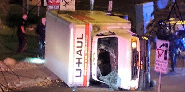 A rental truck lies on its side in Edmonton, Canada, on October 1, 2017, after a high speed chase.Canadian police arrested a man early Sunday suspected of stabbing an officer and injuring four pedestrians in a series of violent incidents being investigated as an 'act of terrorism.' The crime spree began late September 30 outside a football stadium and ended hours later with a high speed chase in which the driver of the rented truck plowed into pedestrians, police said. / AFP PHOTO / MICHAEL MUKAI / ALTERNATIVE CROP (Photo credit should read MICHAEL MUKAI/AFP/Getty Images)