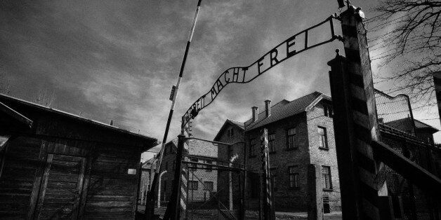 Auschwitz, Poland - March 28, 2008: Main gate of Auschwitz-Birkenau (Auschwitz I) concentration camp in Poland, where 1.1 million people where killed (90% Jews) by the Nazi army during the World War II (1940-1945). The Soviet troop liverated the camp on January 27 in 1945. In the following decades it became a symbol of the Holocaust. In 1947, Poland founded a museum on the site of Auschwitz I and II, and in 1979 it was named a UNESCO World Heritage Site.