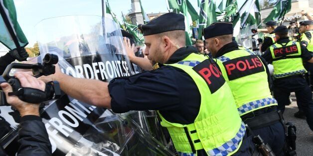 Police officers stop the far-right Nordic Resistance Movement march as it changed the planned route, on September 30, 2017 in Gothenburg, Sweden. / AFP PHOTO / TT News Agency / Fredrik SANDBERG / Sweden OUT (Photo credit should read FREDRIK SANDBERG/AFP/Getty Images)