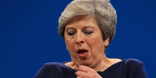 MANCHESTER, UNITED KINGDOM - OCTOBER 04: British Prime Minister and leader of the Conservative Party Theresa May MP stops to cough as she loses her voice during her keynote speech on the final day of the annual Conservative Party Conference in Manchester, north west England on October 04, 2017. (Photo by Lindsey Parnaby/Anadolu Agency/Getty Images)