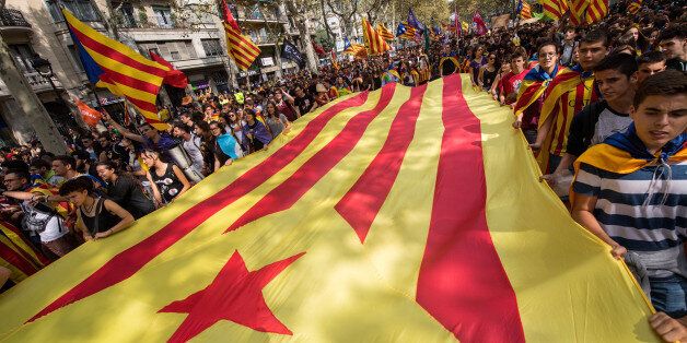 BARCELONA, SPAIN - SEPTEMBER 28: Students carry a big Catalan Pro-Independence flag as they demonstrate against the position of the Spanish government to ban the Self-determination referendum of Catalonia during a university students strike on September 28, 2017 in Barcelona, Spain. The Catalan goverment is keeping with its plan to hold a referendum, due to take place on Octorber 1, which has been deemed illegal by the Spanish government in Madrid. (Photo by David Ramos/Getty Images)