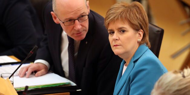 First Minister Nicola Sturgeon, and Deputy First Minister John Swinney (left), during First Minister's Questions at the Scottish Parliament in Edinburgh. (Photo by Jane Barlow/PA Images via Getty Images)