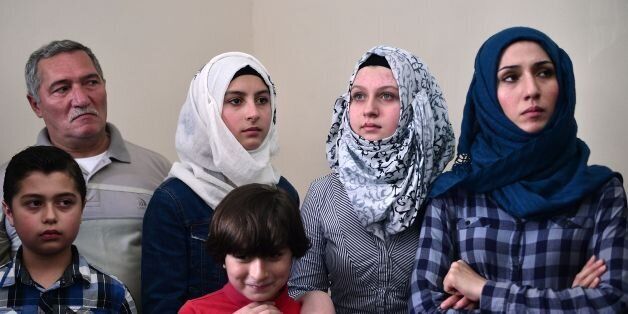 Members of a Syrian refugee family, wait for a visit of UN high commissioner for refugees, in an apartment where they live in Athens, rented to them by the United Nations High Commissioner for Refugees (UNHCR), on August 24, 2016.Samar, who fled Aleppo in Syria, lives in the apartment with her four children and her parents, Mohammad and Fatima, is waiting to be reunited with her husband who is currently elsewhere in Europe. More than 58,000 refugees and migrants are stranded in Greece with most of them living in refugee camps, while some 8,000 live in UNHCR arranged shelters, houses or hotels. / AFP / LOUISA GOULIAMAKI (Photo credit should read LOUISA GOULIAMAKI/AFP/Getty Images)