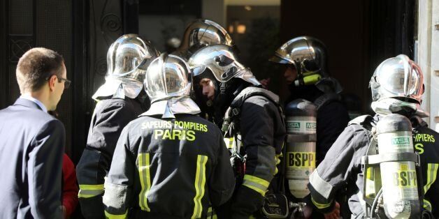 Firefighters work to put out a fire in an apartment building in central Paris on July 25, 2017. / AFP PHOTO / ludovic MARIN (Photo credit should read LUDOVIC MARIN/AFP/Getty Images)