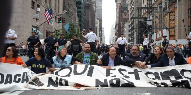 NEW YORK, NY - SEPTEMBER 19, 2017: Activists sit on Fifth Avenue in an action of civil disobedience near Trump Tower on September 19, 2017 in New York, New York. The action was intended to call attention to President Donald Trump's anti-immigration policies, including the rollback of DACA. (Photo by Kevin Hagen/Getty Images)