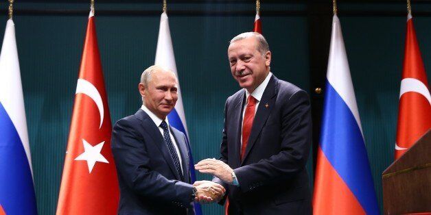 ANKARA, TURKEY - SEPTEMBER 28: Turkish President Recep Tayyip Erdogan (R) and President of Russia, Vladimir Putin (L) shake hands after holding a joint press conference following their meeting, at Presidential Complex in Ankara, Turkey on September 28, 2017. (Photo by Kayhan Ozer/Anadolu Agency/Getty Images)