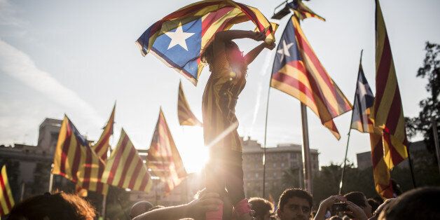 Demonstrators wave Catalan flags while marching through the city to protest against alleged police violence during Sunday's illegal referendum vote in Barcelona, Spain, on Tuesday, Oct. 3, 2017. Prime MinisterÂ Mariano RajoyÂ is fighting to maintain his authority after 2.3 million Catalans voted in Sunday's makeshift referendum and the regional police force ignored orders to prevent the ballot. Photographer: Angel Garcia/Bloomberg via Getty Images