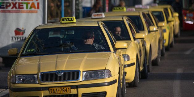 ATHENS, GREECE - JANUARY 26: Taxi drivers wait for customers in Syntagma Square following the electoral success by Syriza in the Greek general election yesterday on January 26, 2015 in Athens, Greece. The radical left party Syriza won the snap Greek general election and has asked the right-wing Independent Greek party to form a anti-austerity coalition. (Photo by Matt Cardy/Getty Images)