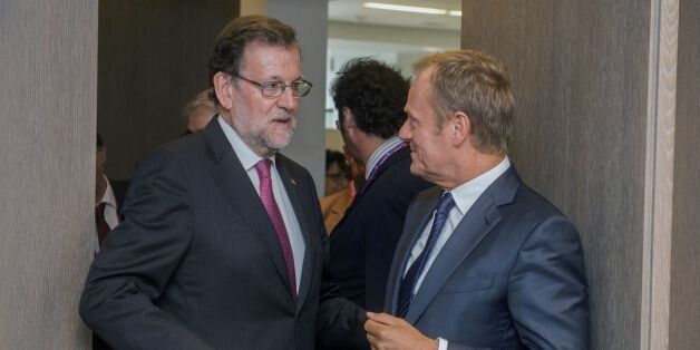 Spanish Prime Minister Mariano Rajoy (L) speaks with European Union Council President Donald Tusk ahead of an European Union summit on June 28, 2016 at the EU headquarters in Brussels. Britain's exit from the European Union may erode the bloc's leadership role in fighting climate change and stymie crucial efforts to set more ambitious targets for cutting greenhouse gases, officials and experts said on June 28. European leaders meeting in Brussels pressured British Prime Minister David Cameron Tuesday to launch the two-year withdrawal process 'as soon as possible', but the embattled premier has vowed he will leave that task to a successor to be named on September 9. / AFP / POOL / STEPHANIE LECOCQ (Photo credit should read STEPHANIE LECOCQ/AFP/Getty Images)