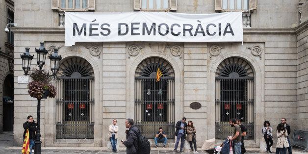 A view of Banner "More democracy" in Barcelona, Spain, on October 1, 2017. More than five million eligible Catalan voters are estimated to visit 2,315 polling stations today for Catalonia's referendum on independence from Spain. The Spanish government in Madrid has declared the vote illegal and undemocratic. (Photo by Marco Panzetti/NurPhoto via Getty Images)