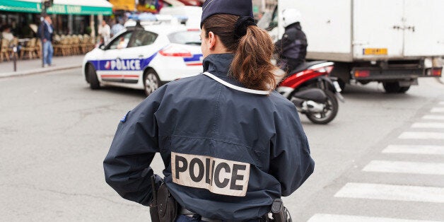 Paris, France - May 15, 2013.Uniformed Paris Police officers patrolling traffic near the River Seine in Paris, France