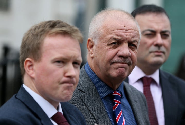 Victims campaigner Raymond McCord (centre) with his lawyers outside of the High Court in Belfast 