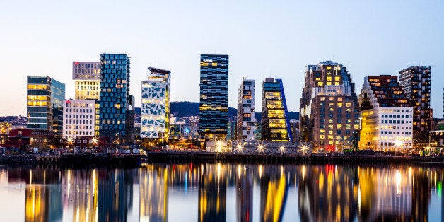 Oslo modern skyline. Several buildings built on the water's edge in the Norwegian capital city. Reflections on the water.