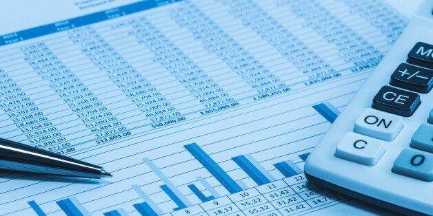 Accounting financial papers analysis charts with calculator, paper and pen in blue