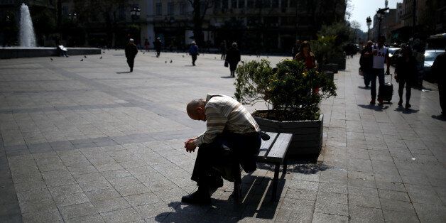 A man sits on a bench at Kotzia square in central Athens, Greece, March 22, 2017. REUTERS/Alkis Konstantinidis
