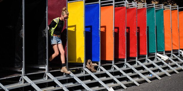 LONDON, ENGLAND - AUGUST 25: A woman helps build some of the hundreds of portable toilets, ahead of the Notting Hill carnival, on August 25, 2017 in London, England. The Notting Carnival has been held annually since 1966 and sees performers and samba bands travel from across the world to take part. Floats at this years carnival will pay their respects to those killed in the Grenfell Tower fire by turning off their music as they pass through a quiet zone near to the remains of the hig-rise tower block. (Photo by Leon Neal/Getty Images)