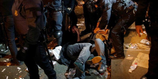 Protesters are pushed by Mossos d'Esquadra riot officers outside the Catalan region's economy ministry building during a raid by Spanish police on government offices, in Barcelona, Spain, early September 21, 2017. REUTERS/Jon Nazca