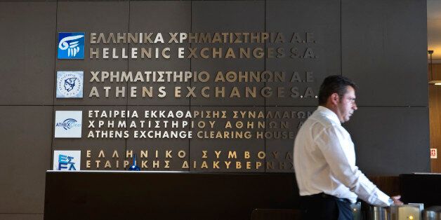 A security officer stands at the entrance to the Athens' stock exchange , Greece July 27, 2015. Greece's stock exchange will remain closed until the government issues a new decree on the bourse, the country's regulator said in a statement on Monday. REUTERS/Ronen Zvulun