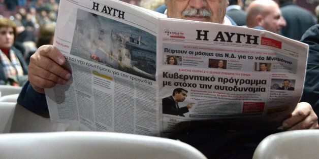 ATHENS, GREECE - 2015/01/03: A SYRIZA supporter reads AVGI newspaper that supports SYRIZA.Alexis Tsipras the president of SYRIZA (Coalition of The Radical Left) political party of Greece gives a speech during SYRIZA political conference at TaeKvownDo center about the coming elections at 25 th of Januarry 2015. (Photo by George Panagakis/Pacific Press/LightRocket via Getty Images)