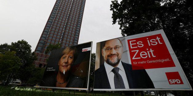 A defaced election campaign poster of the Christian Democratic Union (CDU) party, with a headshot of German Chancellor Angela Merkel and Social Democratic Party (SPD) top candidate Martin Schulz are pictured at a park in Frankfurt, Germany, September 20, 2017. REUTERS/Kai Pfaffenbach