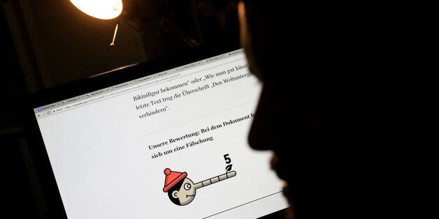 A journalist looks at an internet story rated as 'fake' on the 'Pinocchio scale' in the newsroom of Correctiv, a nonprofit investigative organization, in Berlin, Germany, on Wednesday, Aug. 23, 2017. Germany's parliamentary lower house in June passed legislation threatening fines of up to 50 million euros ($59 million) on large social networks that fail to let users report hate speech or fake news stories, or to remove illegal postings. Photographer: Krisztian Bocsi/Bloomberg via Getty Images