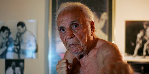 Former middleweight boxing champion Jake LaMotta poses in New York October 28, 2009. LaMotta learned to fight with an ice pick in his hand in a Bronx schoolyard, battering all the way in later life to a world middleweight title in an era of 15-round fights. To match feature BOXING/LAMOTTA REUTERS/Teddy Blackburn (UNITED STATES SPORT BOXING)