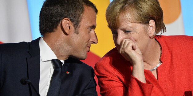 PARIS, FRANCE - AUGUST 28: French President Emmanuel Macron and German Chancelor Angela Merkel react during a press conference after the multinational meeting at Elysee Palace on August 28, 2017 in Paris, France. During the meeting they talked about the politic situation in Europe and the European security issues. (Photo by Aurelien Meunier/Getty Images)