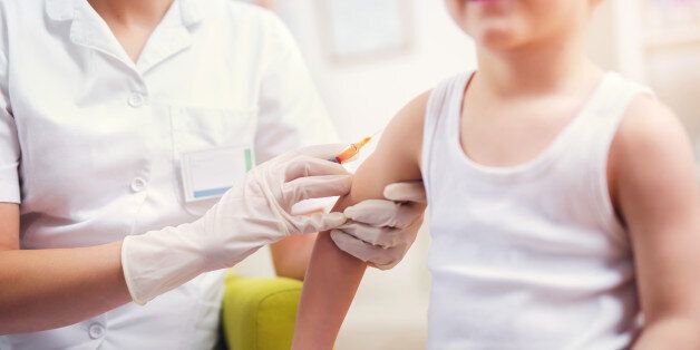 Pediatrician makes vaccination to small boy