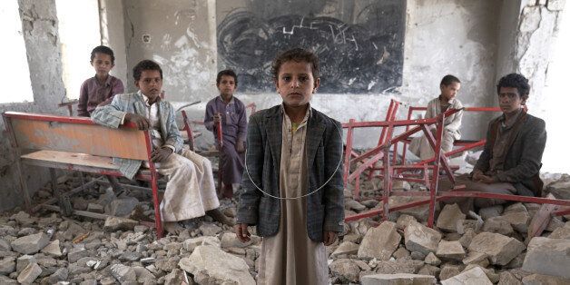 AAL OKAB SCHOOL ,SAADA CITY, YEMEN - 24 APRIL 2017: Young students stand in the ruins of a former classroom of the Aal Okab school. Located in the outskirts of Saada City, the school was destroyed in June 2015. Students now attend lessons in UNICEF tents nearby. Some 2 million school-age children are currently out of school in Yemen today.(Photo by Giles Clarke, UN OCHA / Getty Images)