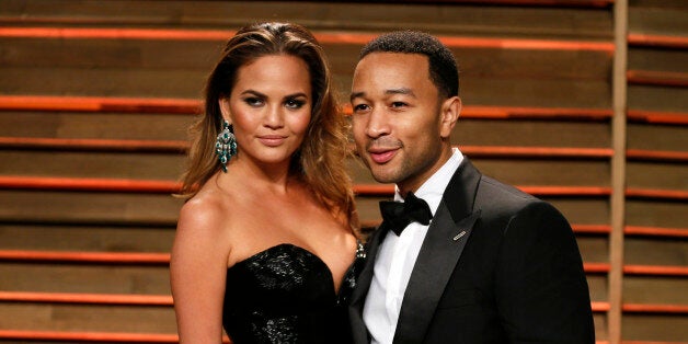 Singer John Legend and wife Chrissy Teigen arrive at the 2014 Vanity Fair Oscars Party in West Hollywood, California March 3, 2014. REUTERS/Danny Moloshok (UNITED STATES TAGS: ENTERTAINMENT) (OSCARS-PARTIES)