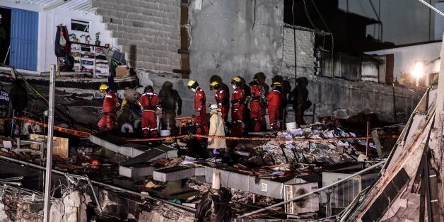 Rescue workers are seen during the search for survivors in Mexico City on September 21, 2017, two days after a strong quake hit central Mexico.A powerful 7.1 earthquake shook Mexico City on Tuesday, causing panic among the megalopolis' 20 million inhabitants on the 32nd anniversary of a devastating 1985 quake. / AFP PHOTO / RONALDO SCHEMIDT (Photo credit should read RONALDO SCHEMIDT/AFP/Getty Images)