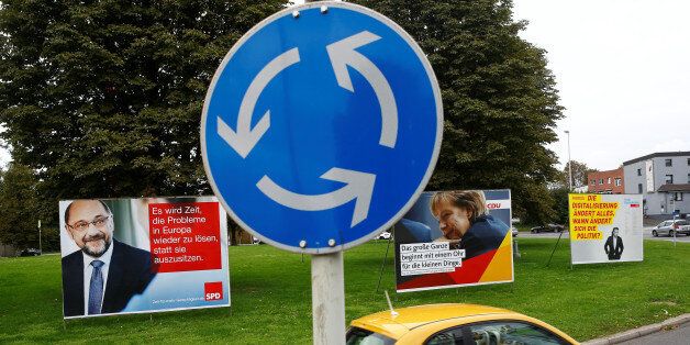 A street sign for a roundabout stands in front of election campaign posters of Martin Schulz of Germany's Social Democratic party SPD, German Chancellor Angela Merkel, the leader of the Christian Democratic Union party CDU, and Christian Lindner, the leader of Germany's Free Democratic party FDP, in Bonn, Germany, September 7, 2017. REUTERS/Wolfgang Rattay
