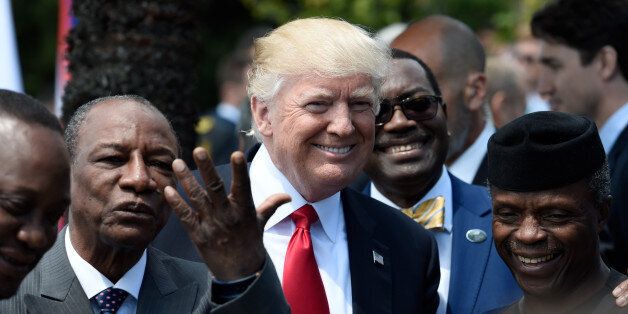 U.S. President Donald Trump shares a laugh with Guinea's President Alpha Conde (L), the Vice President of Nigeria Yemi Osinbajo (R) and other African leaders as they arrive to pose for a family photo with participants of the G7 summit during the Summit of the Heads of State and of Governments of the G7, the group of most industrialized economies, plus the European Union, in Taormina, Sicily, Italy, May 27, 2017. REUTERS/Stephane de Sakutin/Pool