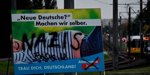 An Alternative for Germany (AfD) campaign poster is vandalised in Berlin on September 21, 2017.Germans go to the polls on September 24th, with the AfD widely expected to garner enough votes to enter the federal parliament.Campaign poster reads: 'New Germans? we'll make them ourselves.' / AFP PHOTO / John MACDOUGALL (Photo credit should read JOHN MACDOUGALL/AFP/Getty Images)