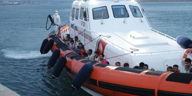 PORT, CROTONE, CALABRIA, ITALY - 2017/06/17: Pakistani irregular migrants arrived in the harbor on board the Coast Guard boat. A 12-meter-long yacht was reported by Crotone's port leader with a board of 45 irregular migrants of Pakistani nationality, coming from Greece, and was reached by a Coast Guard motorboat that operated the harbor in the port of Crotone. (Photo by Antonino D'Urso/KONTROLAB /LightRocket via Getty Images)