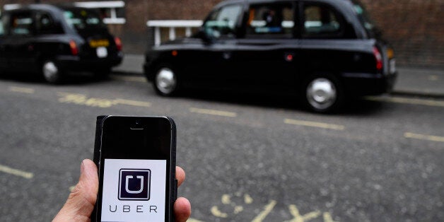 A photo illustration shows the Uber app logo displayed on a mobile telephone, as it is held up for a posed photograph in central London, Britain October 28, 2016. This logo has been updated and is no longer in use. REUTERS/Toby Melville/Illustration