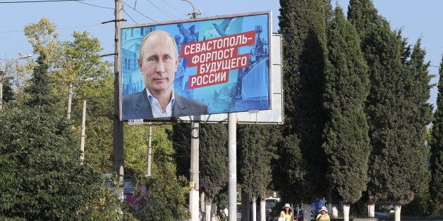 SEVASTOPOL, CRIMEA - AUGUST,19 (RUSSIA OUT) A giant poster with portrait of Russian President Vladimir Putin is seen on the street in Sevastopol, Crimea, August 19, 2017. Poster reads: 'Sevastopol is outpost of the future of Russia'. Sevastopol is located in Crimean Peninsula, a disputed territory between Ukraine and Russia, annexed in 2014. (Photo by Mikhail Svetlov/Getty Images)
