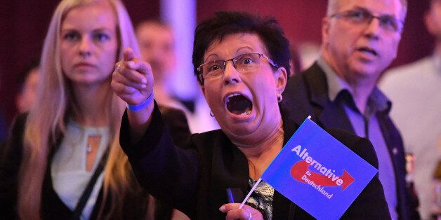 Supporters of the Alternative for Germany (AfD) react after exit poll results were broadcasted on public television at an election night event in Erfurt, eastern Germany during the general election on September 24, 2017.The Alternative for Germany (AfD) became the first hard-right, openly anti-immigration party to enter parliament in force since World War II, breaking a taboo despite mainstream parties' calls to halt 'the Nazis' in their tracks. / AFP PHOTO / dpa / Martin Schutt / Germany OUT (Photo credit should read MARTIN SCHUTT/AFP/Getty Images)