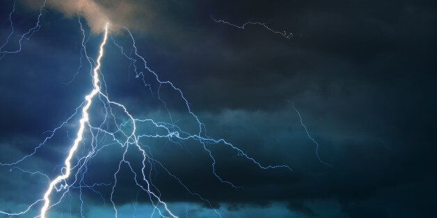 Fork lightning striking down during summer storm.