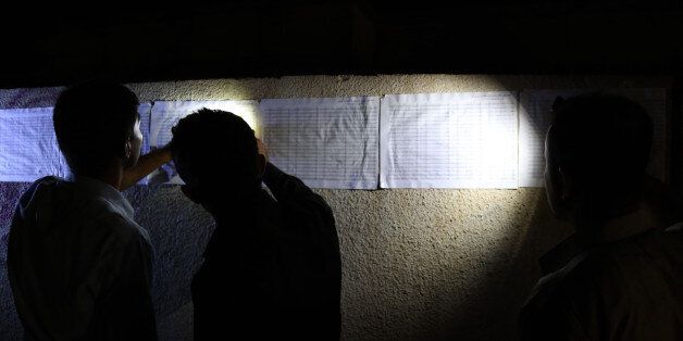 Iraqi Kurds check for their names on the voting lists posted outside a polling station in Arbil, the capital of the autonomous Kurdish region of northern Iraq, on the eve on the Kurdish independence referendum on September 24, 2017. / AFP PHOTO / SAFIN HAMED (Photo credit should read SAFIN HAMED/AFP/Getty Images)