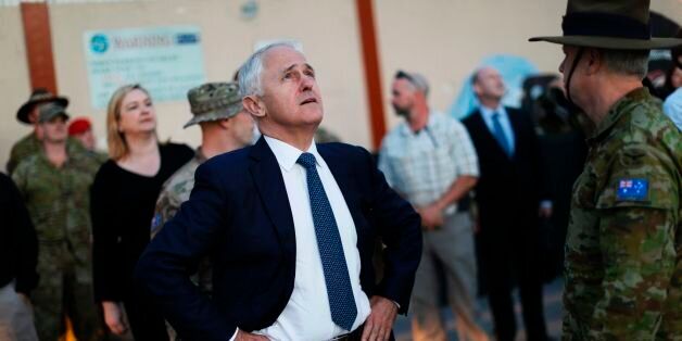Australia's Prime Minister Malcolm Turnbull looks at an helicopter passing overhead at Resolute Support headquarters in Kabul, on April 24, 2017, ahead of a meeting with US Defence Secretary.US Defense Secretary Jim Mattis arrived in Afghanistan on an unannounced visit April 24, an American defence official confirmed, hours after his Afghan counterpart resigned over a deadly Taliban attack. Mattis, making his first visit to Afghanistan as Pentagon chief, was due to meet top officials including President Ashraf Ghani less than two weeks after the US dropped its largest non-nuclear bomb on Islamic State hideouts in the country's east. / AFP PHOTO / POOL / JONATHAN ERNST (Photo credit should read JONATHAN ERNST/AFP/Getty Images)