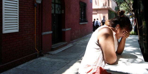 A woman reacts after an earthquake hit Mexico City, Mexico September 19, 2017. REUTERS/Carlos Jasso