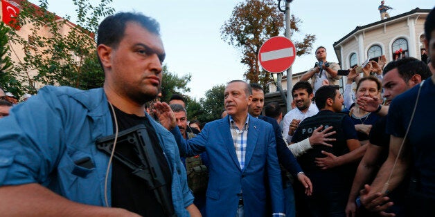 Turkish President Tayyip Erdogan walks through the crowd of supporters protected by bodyguards in Istanbul, Turkey, July 16, 2016. REUTERS/Murad Sezer TPX IMAGES OF THE DAY