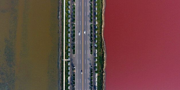 YUNCHENG, CHINA - OCTOBER 02: Aerial view of the colorful salt lake on October 2, 2016 in Yuncheng, Shanxi Province of China. The salt lake displaying red and green colors in Yuncheng attract tourists during the National Day holiday. Formed about 500 million years ago, the salt lake owns different colors as a result of the algae in the water. (Photo by VCG/VCG via Getty Images)